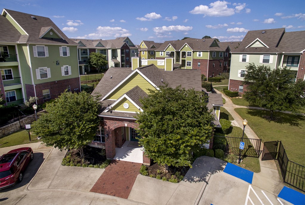 an aerial view of an apartment complex with rows of houses