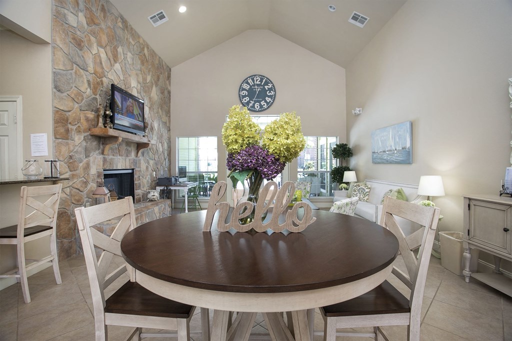 a dining room with a table and a clock on the wall