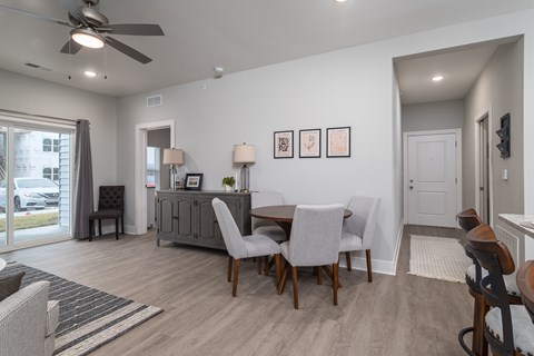 A modern dining room with a wooden table and chairs.