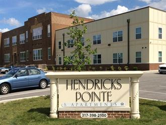 a sign for hendricks point apartments in front of a building
