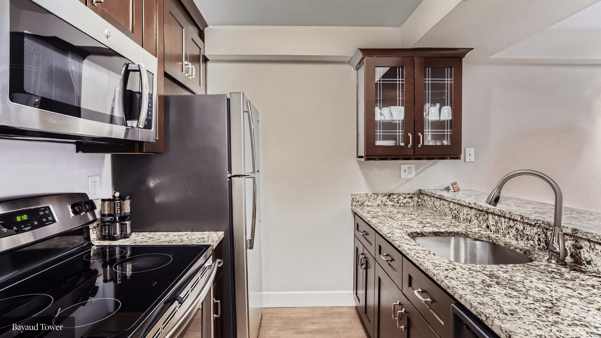 A kitchen with a black stove top oven and a black refrigerator.