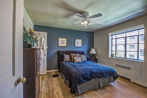 a bedroom with a bed and a ceiling fan