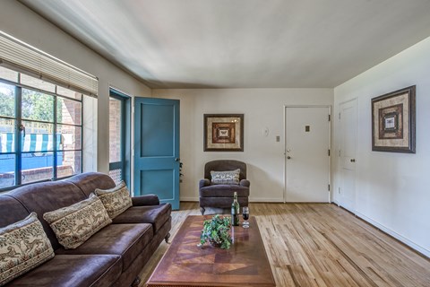 a living room with a blue door and a couch and a coffee table