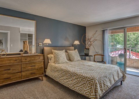a bedroom with a bed and a dresser and a window