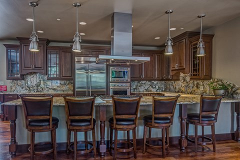 a kitchen with a large island with bar stools