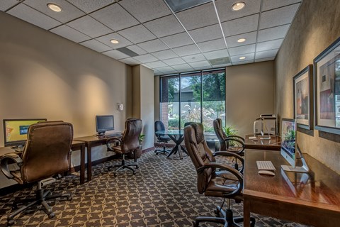 a conference room with desks and chairs and a window