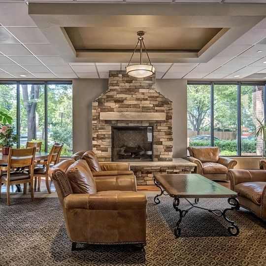 a living room with couches and chairs and a fireplace