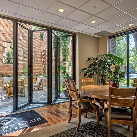 a dining room with a table and chairs and sliding glass doors