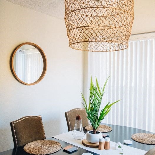 a dining room with a table and a potted plant