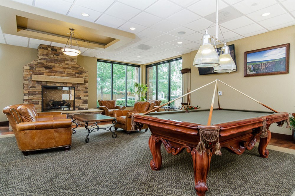 a game room with a pool table and a fireplace