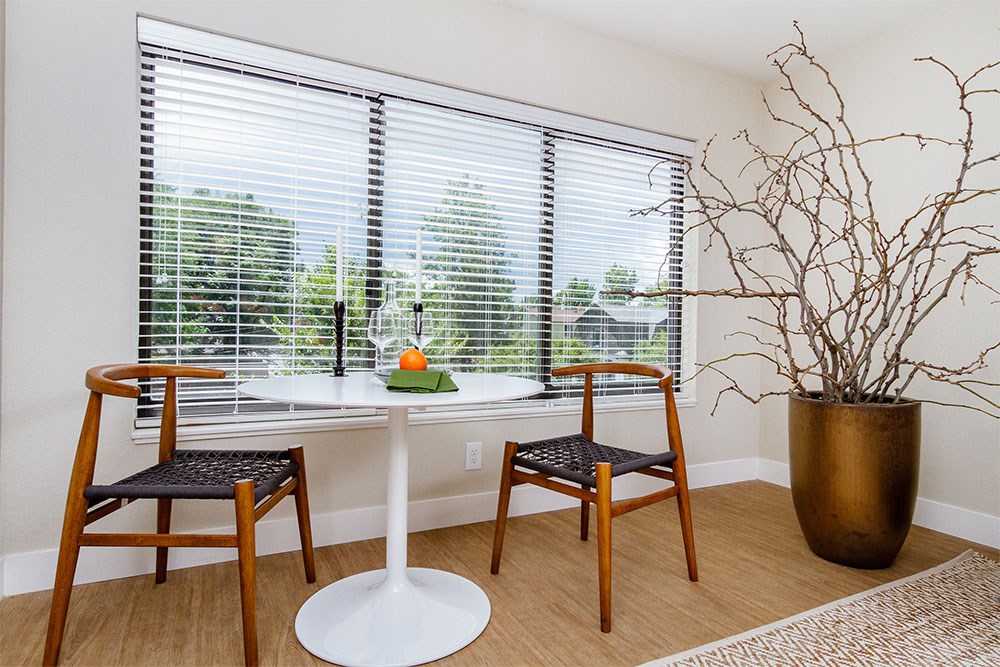 a dining room with a table and chairs and a window
