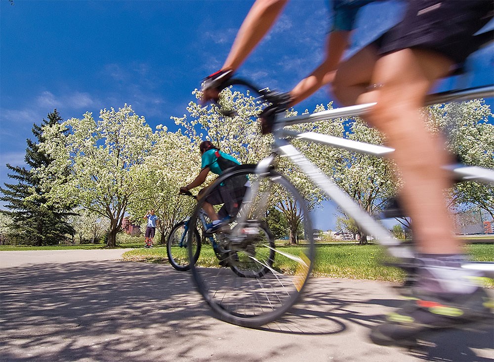 a group of people riding bikes down a street