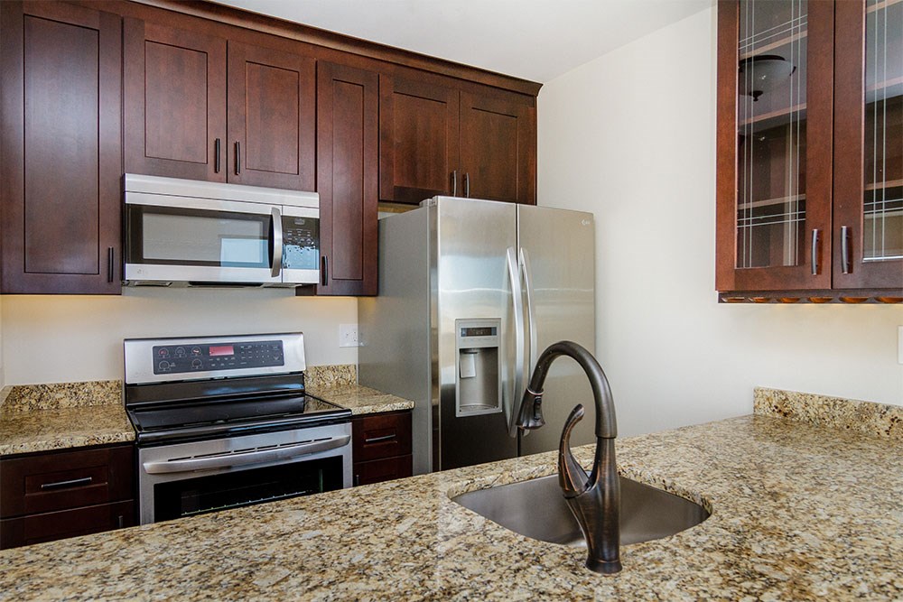 a kitchen with granite counter tops and stainless steel appliances