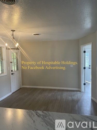 A room with a marble floor and walls, with a note that says "Property of Hostipable Holdings. No Facebook Advertising."