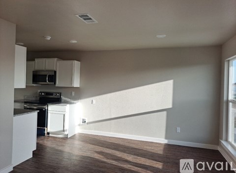A kitchen with white cabinets and a black stove top oven.