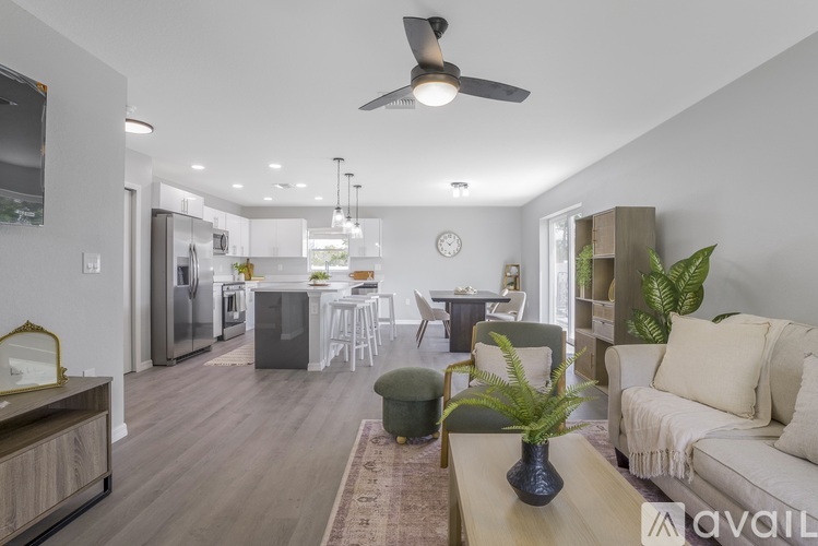 A living room with a couch, a coffee table, and a ceiling fan.