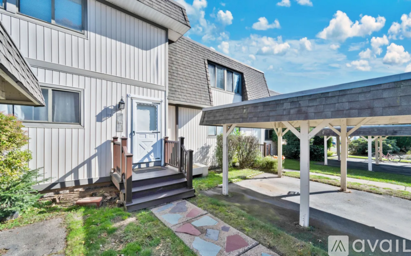 A house with a porch and a covered walkway.