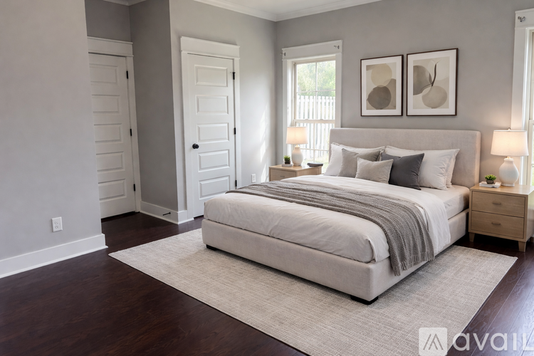 A bedroom with a large bed and two nightstands.