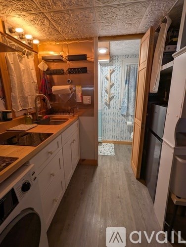 A kitchen with wooden cabinets and a washing machine.