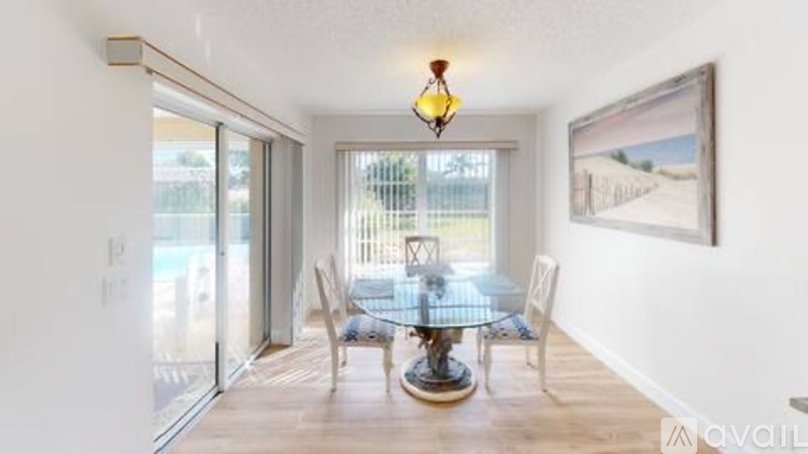 A dining room with a glass table and chairs.