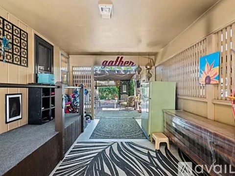 A room with a zebra print rug and a wooden bench.