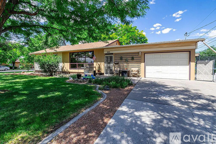 A house with a garage and a driveway in front of it.