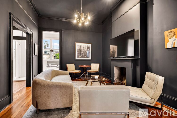 A living room with a fireplace and a television.