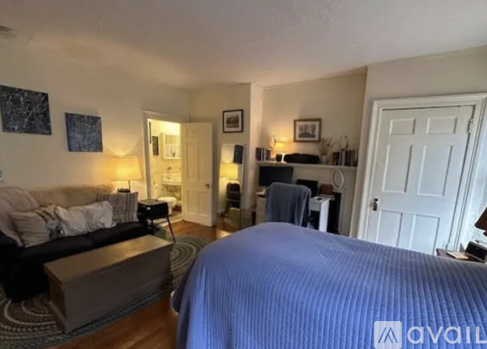 A bedroom with a large bed and a couch.