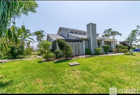 A house with a well-maintained lawn in front of it.