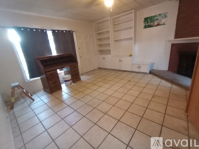 A room with a fireplace and a TV stand.