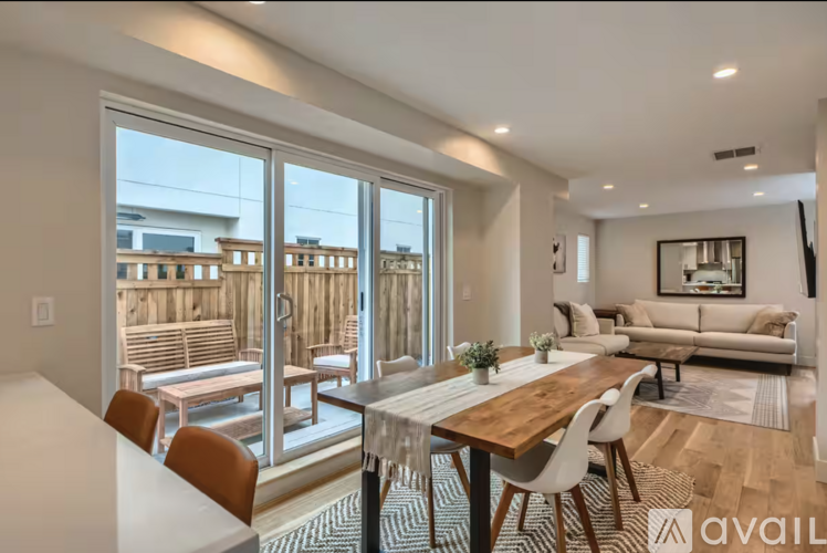 A modern dining room with a wooden table and chairs.