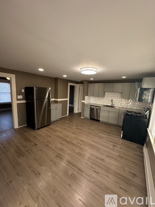 A kitchen with a refrigerator, a dishwasher, and a microwave.
