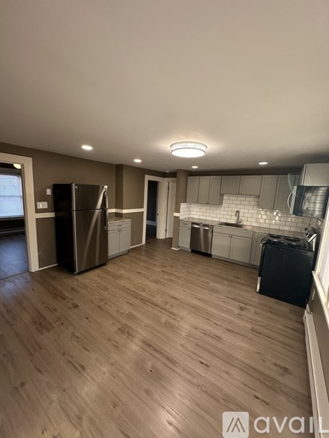 A kitchen with a refrigerator, a dishwasher, and a microwave.