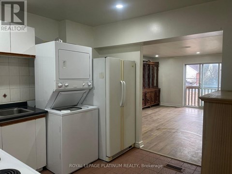 A kitchen with white appliances and wooden floors.