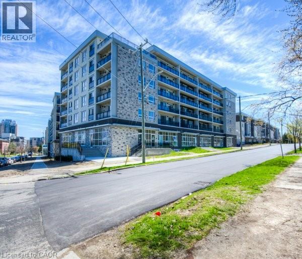 A large, modern apartment building with a flat roof and multiple balconies.