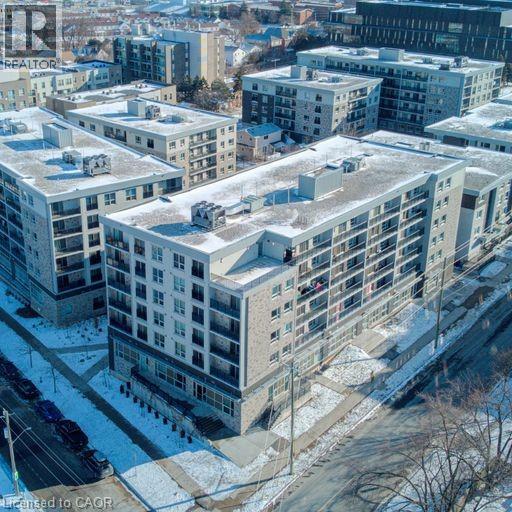 Apartment buildings with snow on the ground and rooftops.