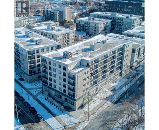 Apartment buildings with snow on the ground and rooftops.