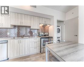 A modern kitchen with wooden cabinets and a washing machine.