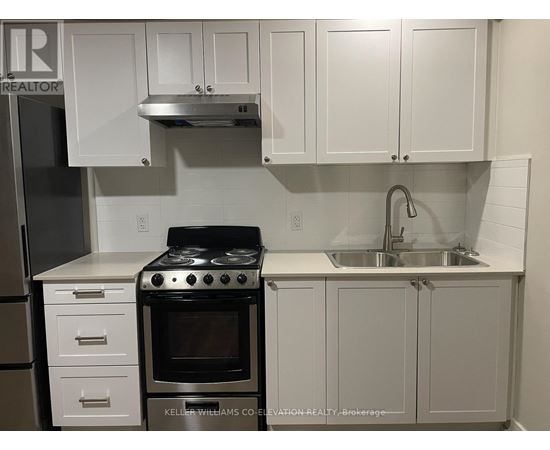 A white kitchen with a stove and cabinets.