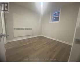A room with a window and a radiator on the wall.