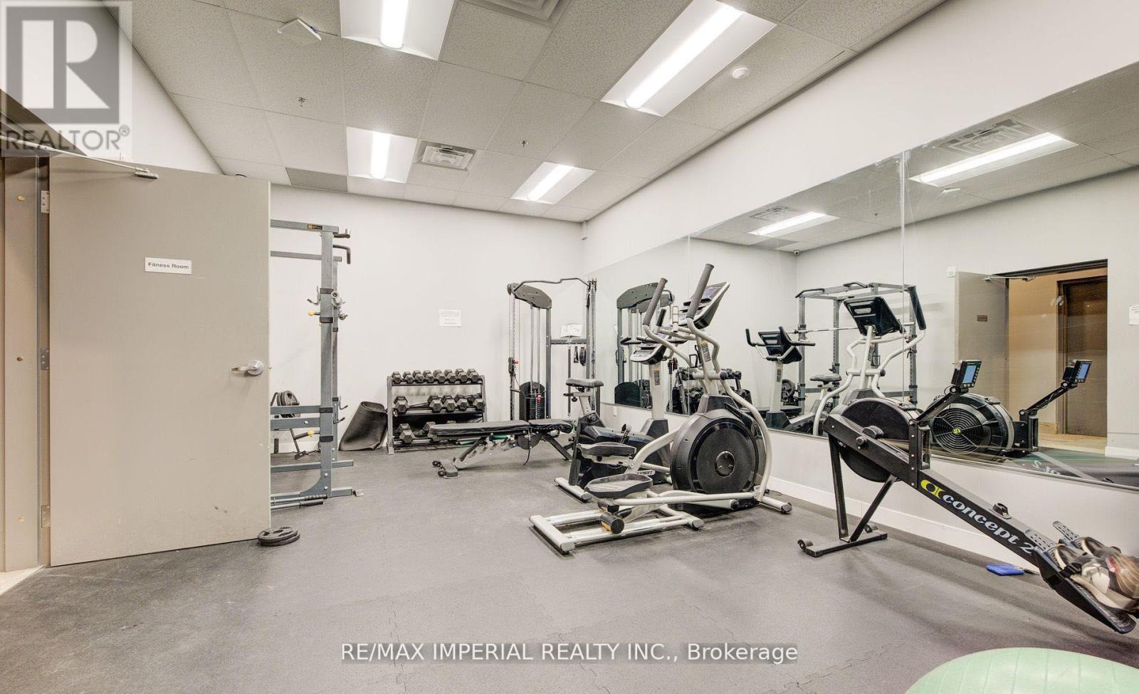 A gym with a variety of equipment including a rowing machine.