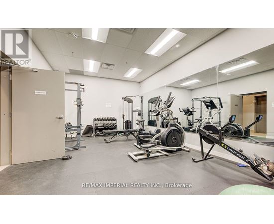 A gym with a variety of equipment including a rowing machine.