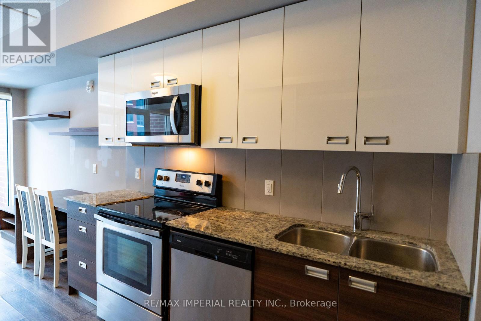 A kitchen with a stove, oven, and microwave.