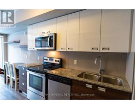 A kitchen with a stove, oven, and microwave.