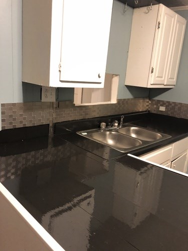 A kitchen with a sink and cabinets.