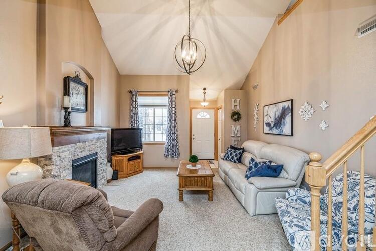 A cozy living room with a fireplace and a couch.