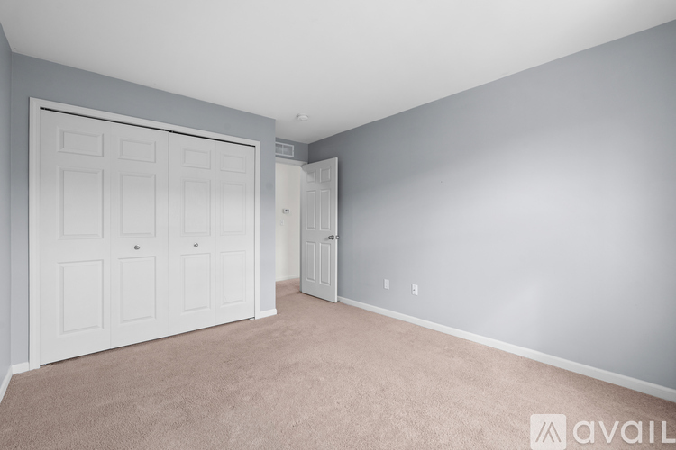 A bedroom with a large bed and a window.