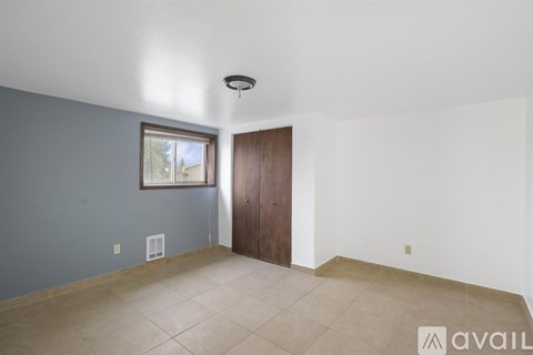 A room with a brown door and a window.