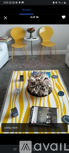 Two yellow chairs are placed in front of a white wall.