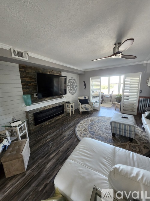 A living room with a fireplace and a television.